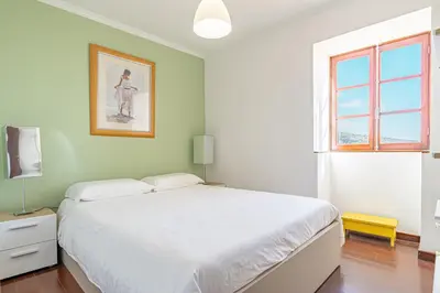 a kitchen and dining room with a table with fruit on it at Vila Pitaias in Estreito da Calheta