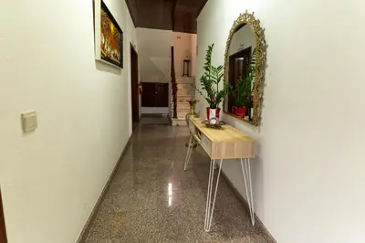 a hallway with a table and a mirror on a wall at Madeira Inn Paradise in Ribeira Brava