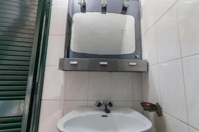 a bathroom with a sink and a mirror on the wall at Madeira Inn Paradise in Ribeira Brava