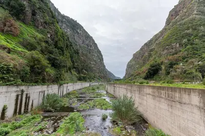 a dam in a canyon with a mountain at Madeira Inn Paradise in Ribeira Brava