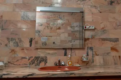 a bathroom with a sink and a mirror at Madeira Inn Paradise in Ribeira Brava