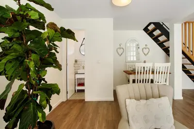 a hallway with white walls and areath on the wall at Casa Francisco in São Vicente