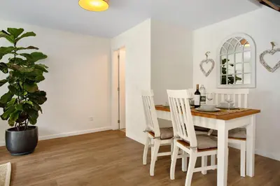 a living room with a chair and a plant at Casa Francisco in São Vicente