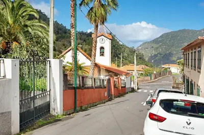 a white car parked on a street next to a church at Casa Francisco in São Vicente