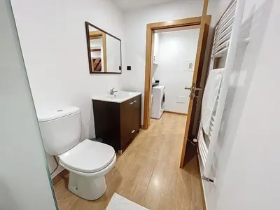 a bathroom with a toilet and a sink and a mirror at Casa do Avô in Santana