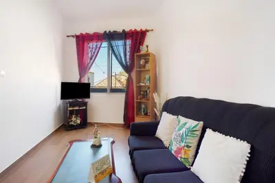 a living room with a blue couch and a table at Casa Orquidea T3 in Ponta do Sol