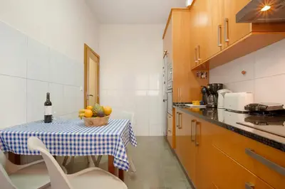 a kitchen with a table with a bowl of fruit on it at Casa Orquidea T3 in Ponta do Sol