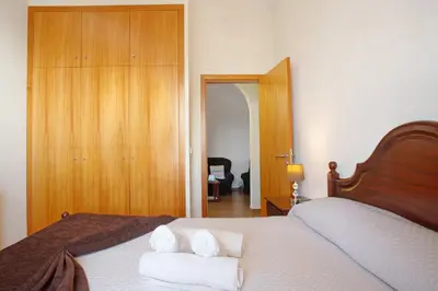 a bedroom with a bed with towels on it at Casa Orquidea T3 in Ponta do Sol