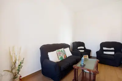 a living room with two chairs and a couch at Casa Orquidea T3 in Ponta do Sol