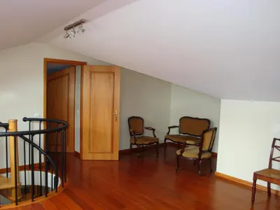 a living room with three chairs and a staircase at Excelente T3 Duplex Funchal in Funchal