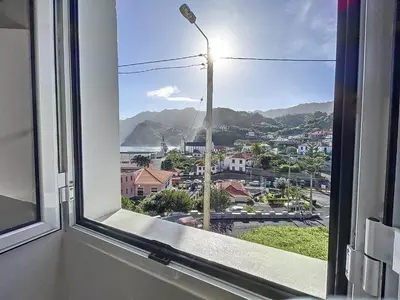 a window with a view of a city at Dinos Sea View in Machico