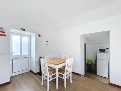 a kitchen and dining room with a table and chairs at Dinos Sea View in Machico