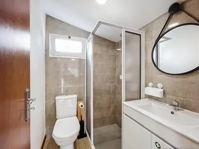 a bathroom with a toilet and a sink and a mirror at Dinos Sea View in Machico