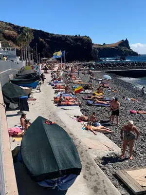 a group of people laying on a beach at Ocean View Condo in Caniço