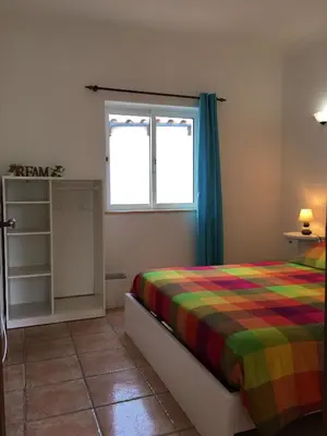 a bedroom with a bed and a window at Carrapateira Lodge in Carrapateira