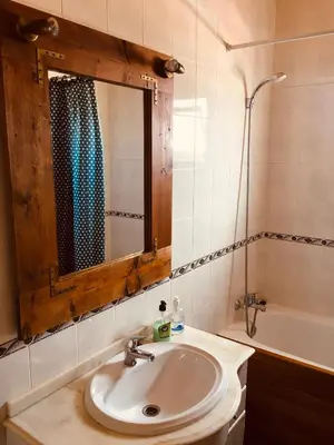 a bathroom with a sink and a mirror and a tub at Carrapateira Lodge in Carrapateira