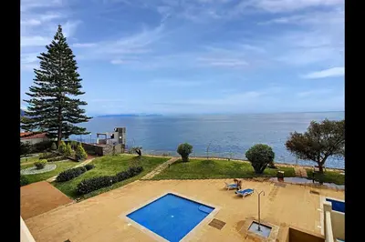 an aerial view of a swimming pool and the ocean at CloudyBay by Turin in Funchal