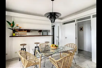 a dining room with a glass table and chairs at CloudyBay by Turin in Funchal