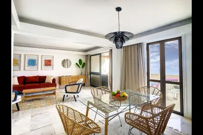 a living room with a glass table and chairs at CloudyBay by Turin in Funchal