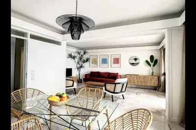 a living room with a table and chairs at CloudyBay by Turin in Funchal