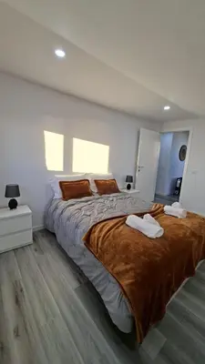 a bedroom with a large bed with two towels on it at Casa Anjinho in Estreito da Calheta