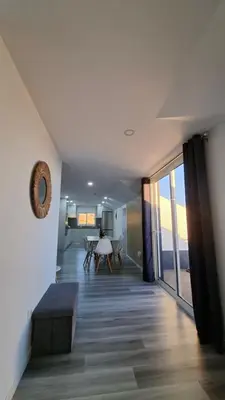 a living room with a view of a dining room and a table at Casa Anjinho in Estreito da Calheta