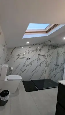 a bathroom with a toilet and a wall mural at Casa Anjinho in Estreito da Calheta
