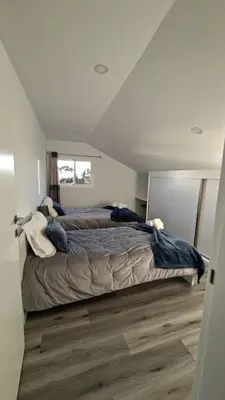 a bedroom with a large bed in a attic at Casa Anjinho in Estreito da Calheta