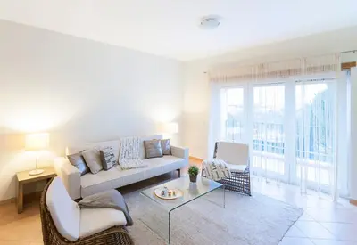 a living room with a couch and a table at Apartamentos Villa T2 Vila Sagres in Sagres