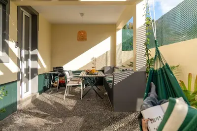 a balcony with a table and chairs in a house at Bela de Santiago II by An Island Apart in Funchal