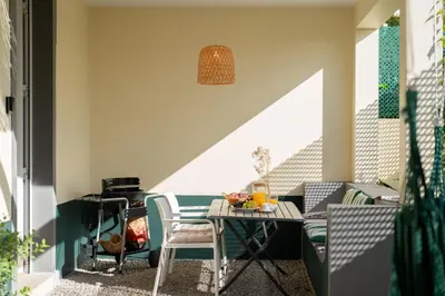 a small balcony with a table and chairs on a balcony at Bela de Santiago II by An Island Apart in Funchal
