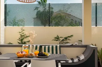 a table with bowls of fruit and drinks on it at Bela de Santiago II by An Island Apart in Funchal
