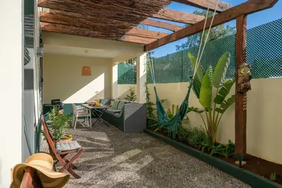 an outdoor patio with a swing and plants at Bela de Santiago II by An Island Apart in Funchal