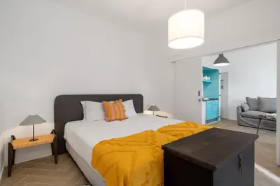a bedroom with a bed with a yellow blanket on it at Bela de Santiago II by An Island Apart in Funchal