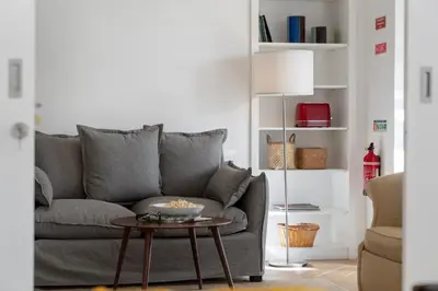 a living room with a gray couch and a table at Bela de Santiago II by An Island Apart in Funchal