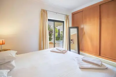 a bedroom with a bed with two towels on it at Casa Clara Sun, Beach and Pool in Lagos