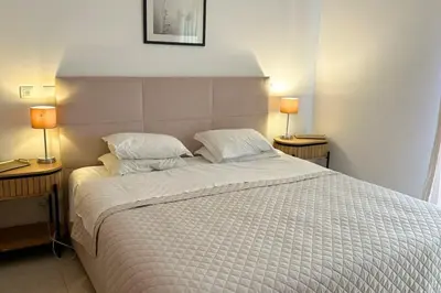 a bedroom with a large bed with two lamps at Casa Clara Sun, Beach and Pool in Lagos