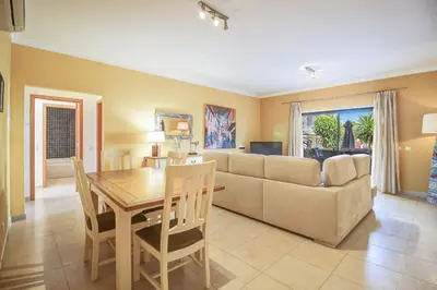 a living room with a couch and a table at Casa Clara Sun, Beach and Pool in Lagos