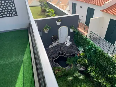 a white marble bathroom with a toilet and a towel at VILLA HELENA Amber Apartment in Caniço