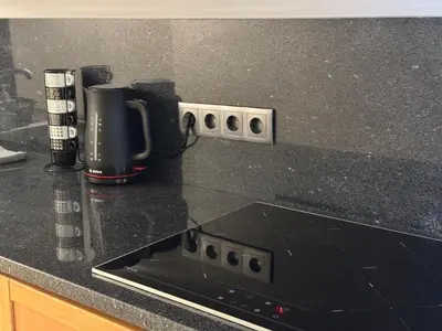 a kitchen counter with a black counter top at Prazeres Natura in Prazeres