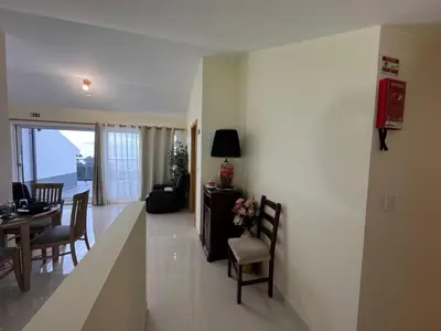 a living room and dining room with a table and chairs at Prazeres Natura in Prazeres