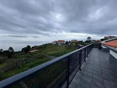a view of the ocean from the balcony of a house at Prazeres Natura in Prazeres