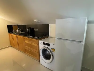 a kitchen with a refrigerator and a washing machine at Prazeres Natura in Prazeres