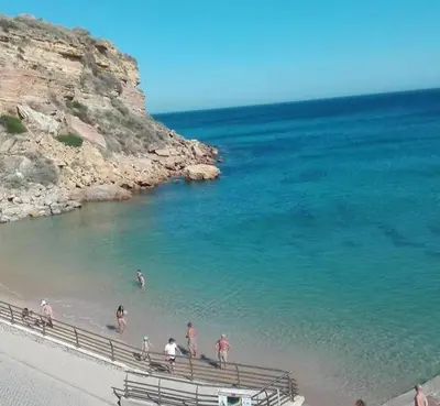 a group of people on a beach near the ocean at Villa Burgau in Lagos