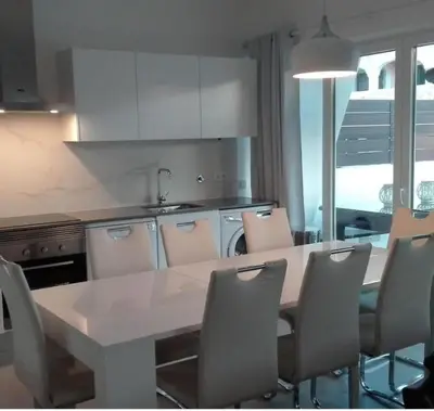 a kitchen with a white table and chairs at Villa Burgau in Lagos