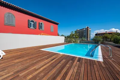 a deck with a swimming pool on top of a building at Luxury Villa Nogueira IV by Holiday Rental Madeira in Funchal