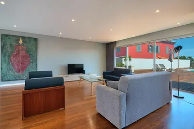 a living room with two chairs and a television at Luxury Villa Nogueira IV by Holiday Rental Madeira in Funchal