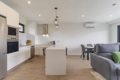 a kitchen and living room with a couch and a table at Orquídea Apartment by Holiday Rental Madeira in Funchal