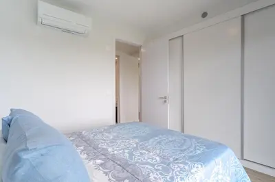 a bedroom with a bed with a blue blanket at Orquídea Apartment by Holiday Rental Madeira in Funchal