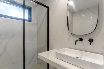 a white bathroom with a sink and a mirror at Orquídea Apartment by Holiday Rental Madeira in Funchal